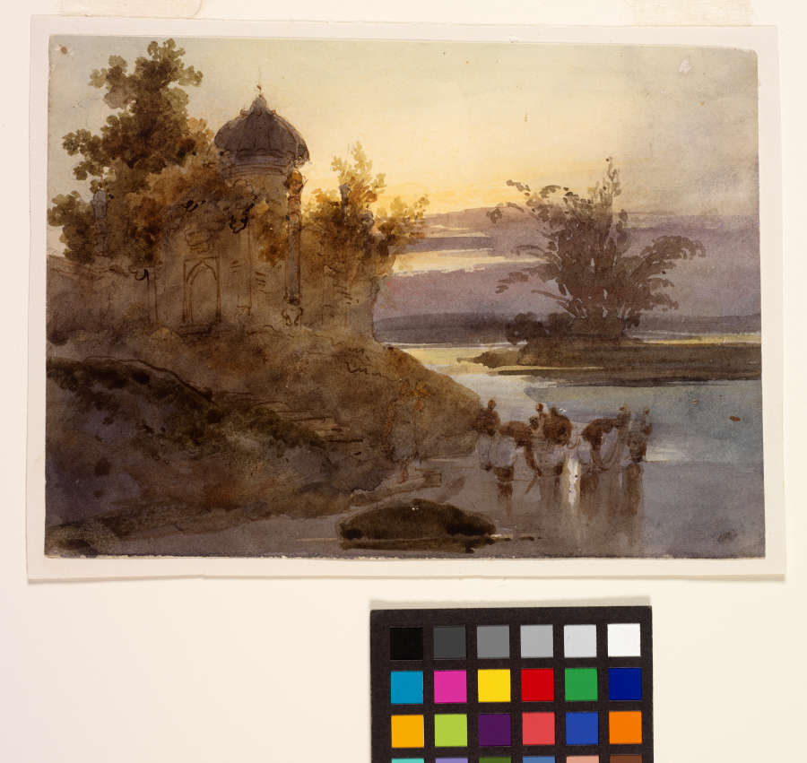 A watercolor and ink painting of a violet and yellow sunset over India’s Ganges River. A dome topped building sits atop the bank, with figures bathing in the river below.