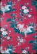 Segment of vintage wallpaper featuring a pattern of bright white cranes within idyllic pond scenes. The vignettes are decorated with blue floral motifs on a deep red background.