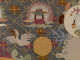 Robe’s back detail. A temple roof framed by clouds is above a golden circle and white bird, and beside a white circle featuring a rabbit, against a dark gridded background.