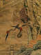 Detail of the scroll, showing two birds facing left on the side of a rock formation. One bird’s beak points downwards while the other points up.