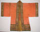 The front of an orange robe laid flat with wide rectangular sleeves. Gold, red, and green embroidery along the sleeves, collar, and bottom hem feature mythical creatures and floral patterns.