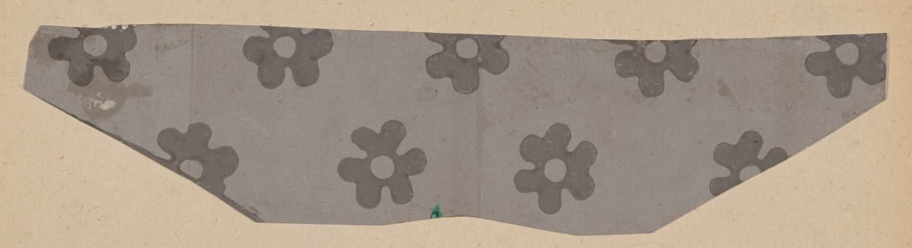 A gray trapezoidal fragment with repeating dark gray flowers.