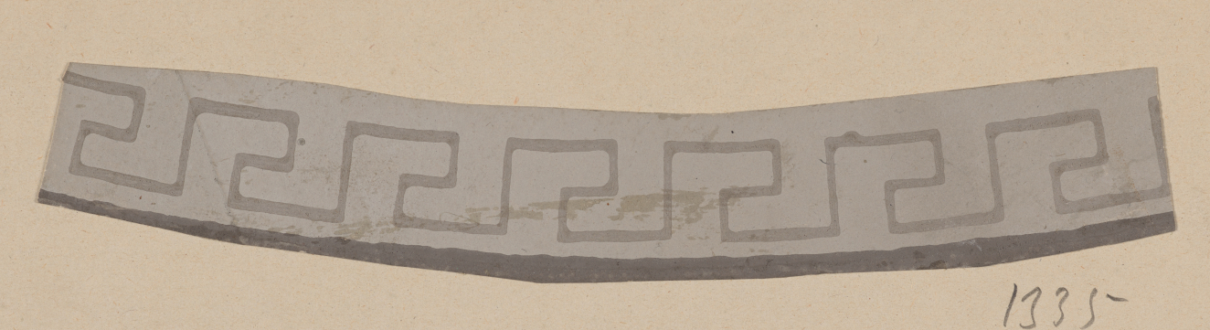 Gray curved strip on a neutral backdrop featuring a geometric repeat in slightly darker shades above a dark edge.