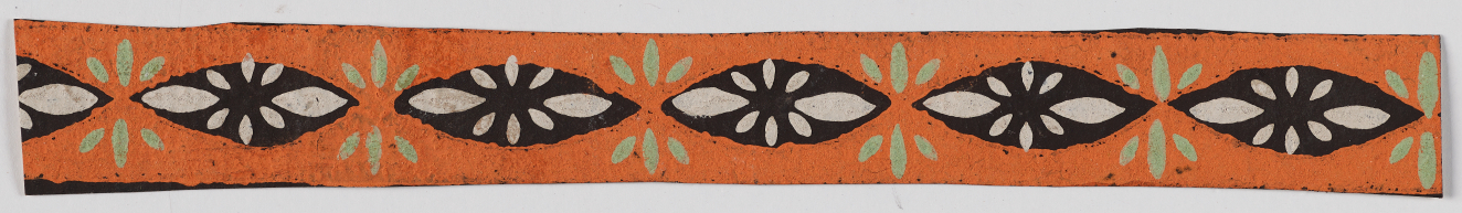 Thin orange horizontal design on a white background featuring black ovals with white floral centers alternating with small gray radiating lines.